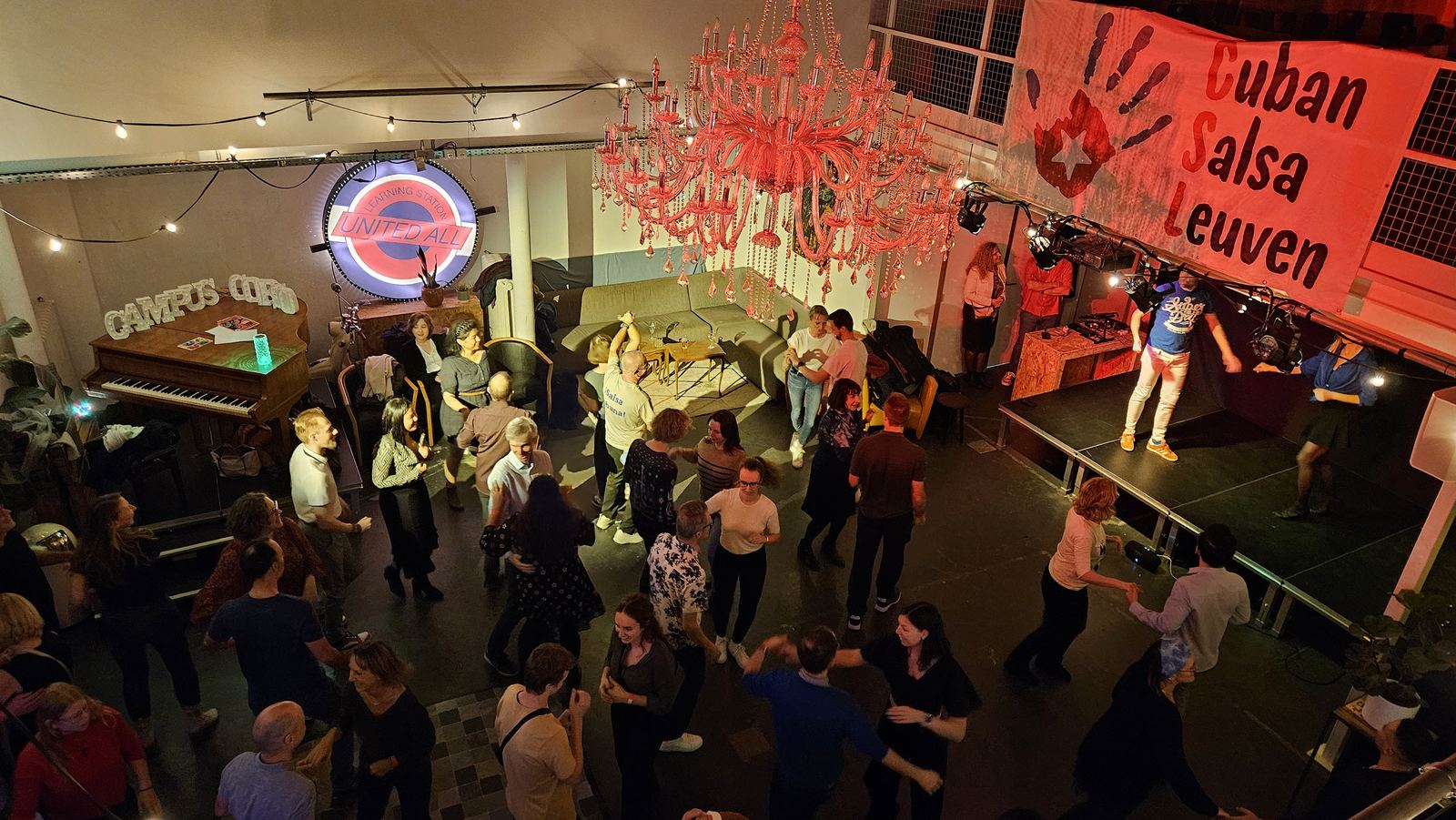 A busy dance hall full of couples dancing Cuban salsa at a club night